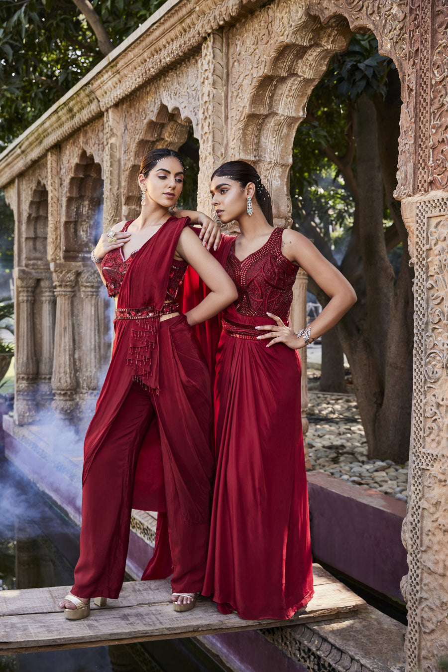 Red Gown With Sari Drape And An Embroidered Belt.